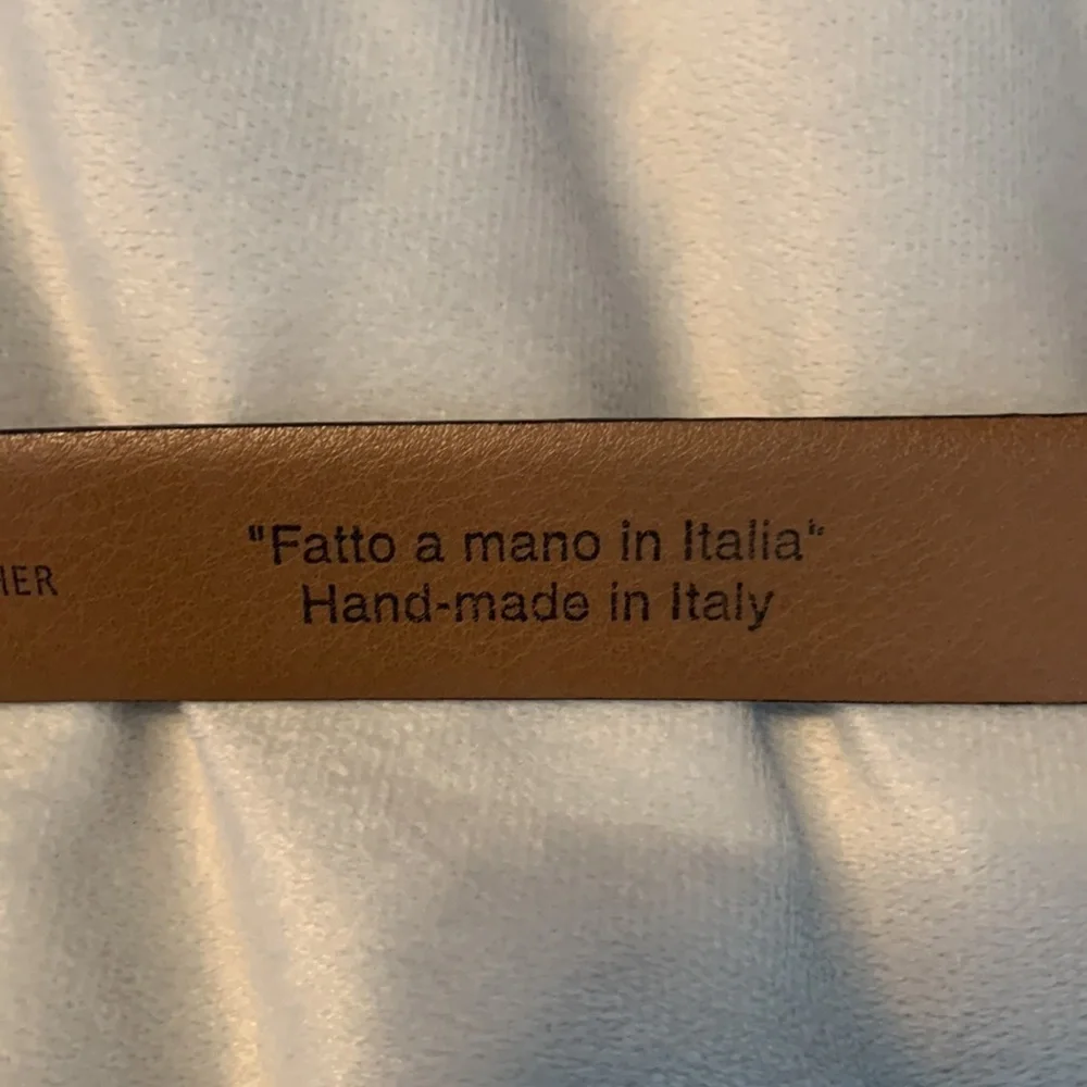 The mens warehouse smooth brown leather belt made in Italy size 38 thin dressy